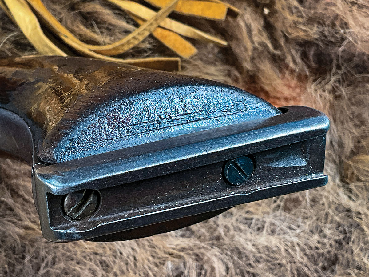 A faint “M. BOUYER” is stamped into the grain of the left grip.